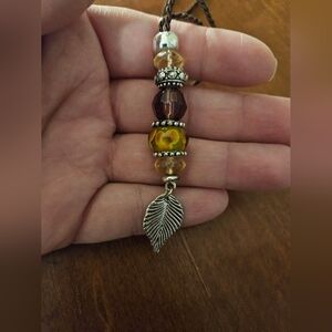 Silver tone leaf and flower charm necklace